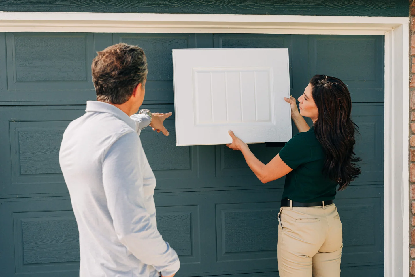 Garage door sales technician showing a panel design