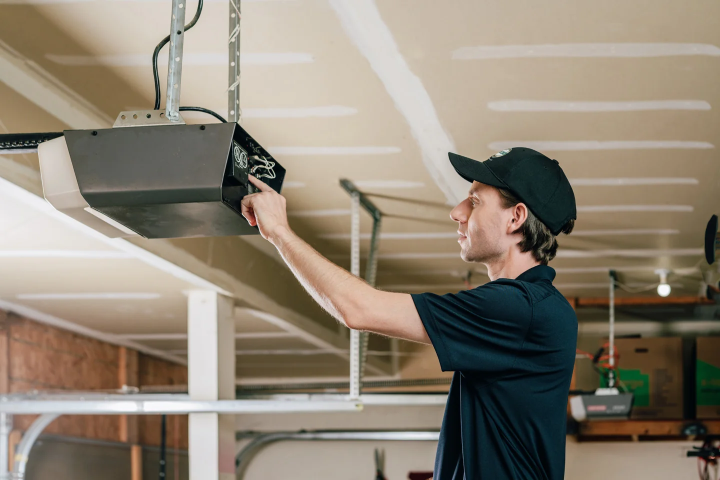 Precision technician fixing a garage door opener