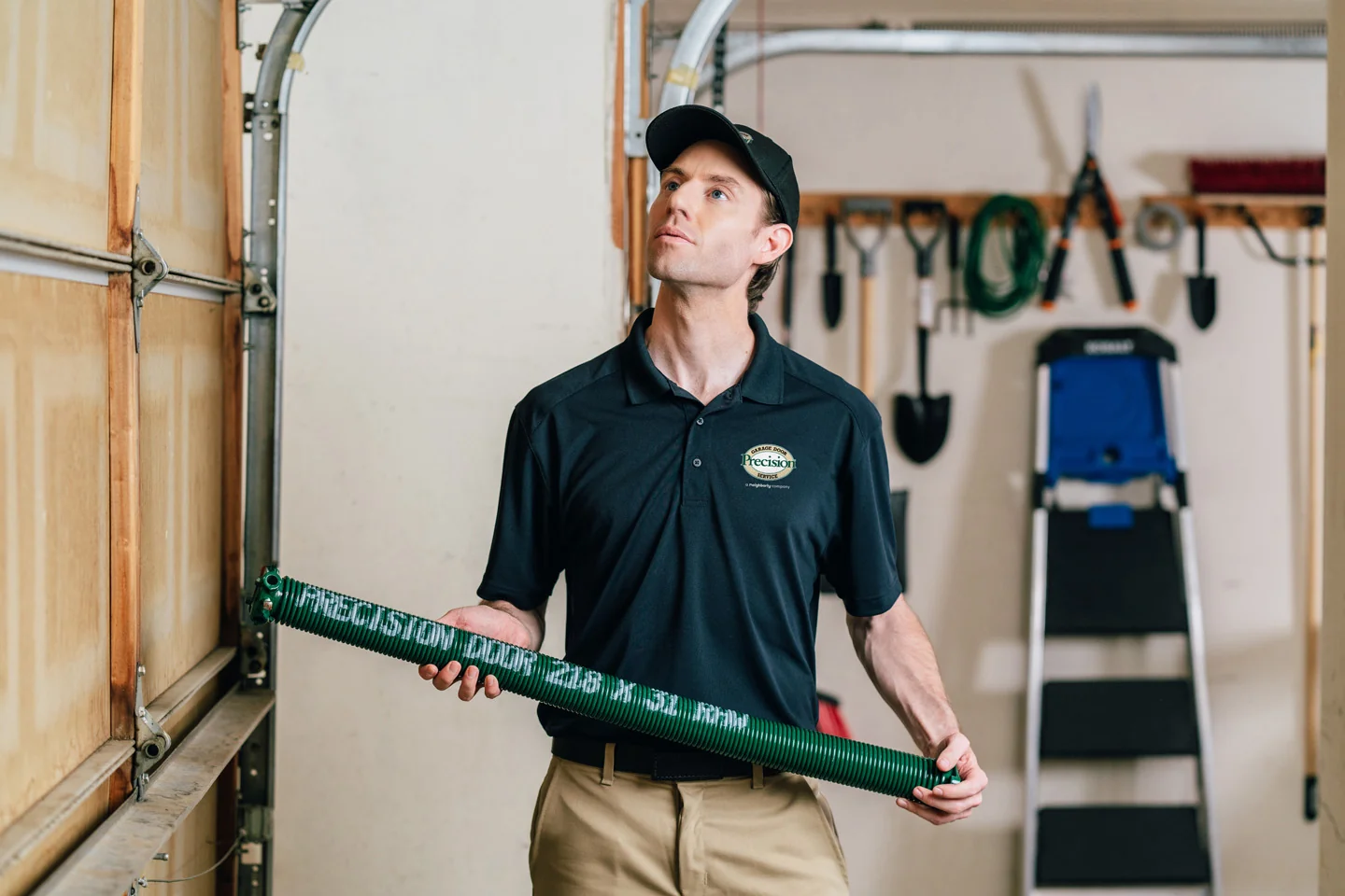 Technician holding a garage door spring