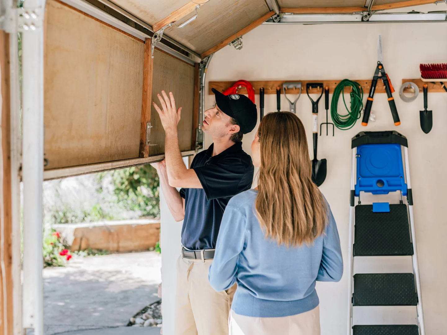Precision technician inspecting one of the types of garage door bottom seals Precision technician inspecting one of the types of garage door bottom seals
